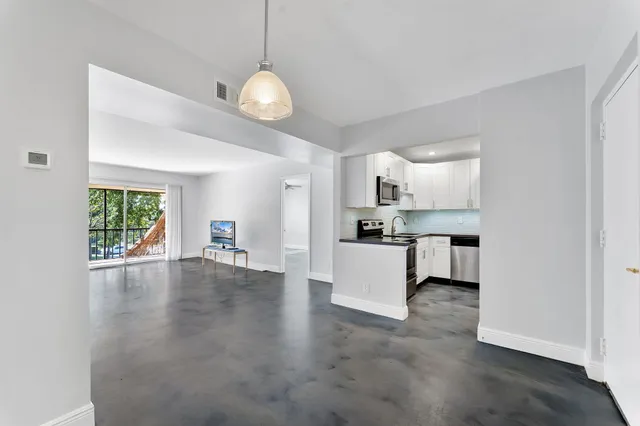 a view of kitchen with microwave and wooden floor