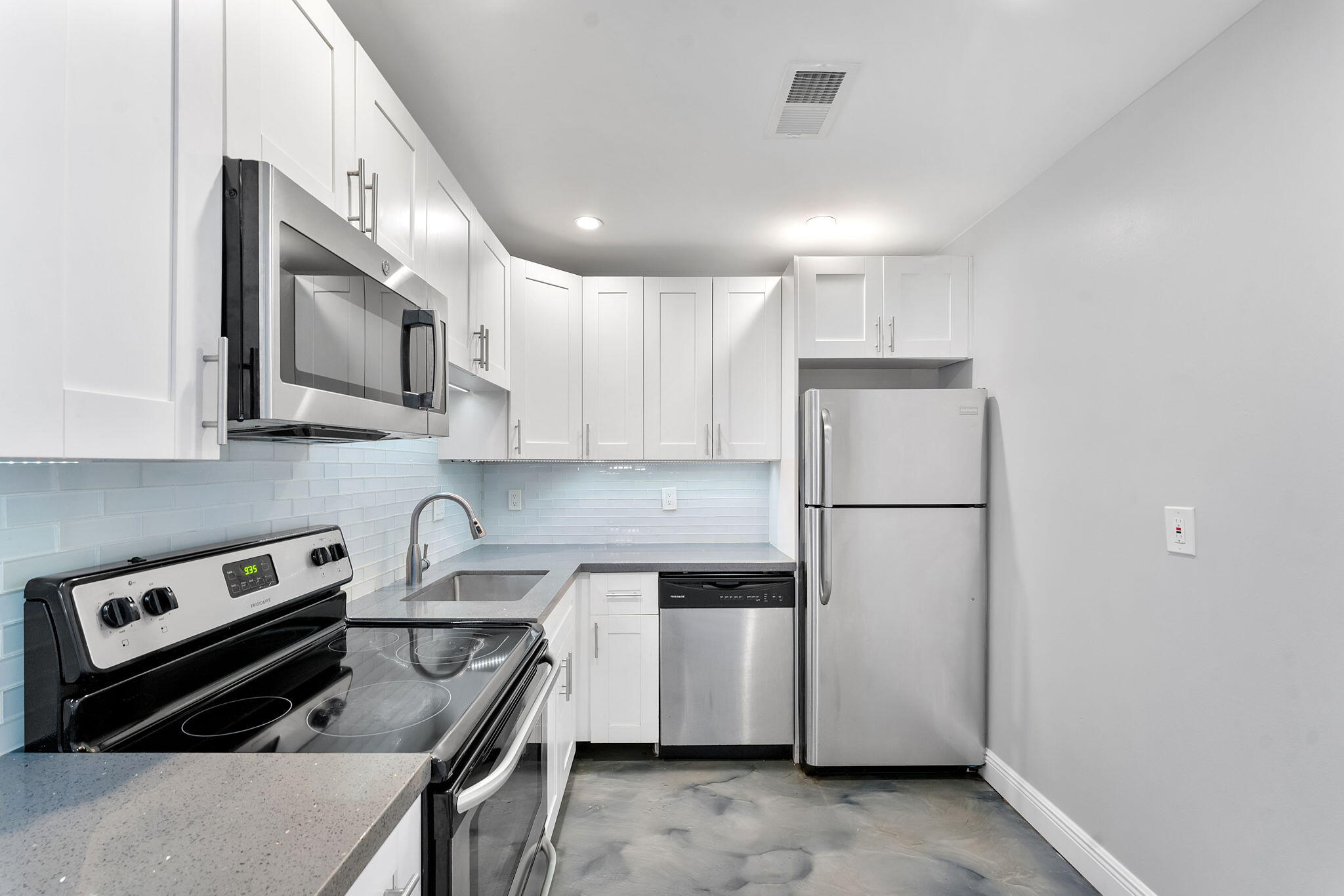 470 Northwest 20th Street, Unit 3070 Boca Raton, FL 33431 - Photo 3 of 22 a kitchen that has a refrigerator a stove and white cabinets