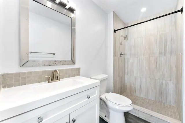 a bathroom with a sink toilet and shower