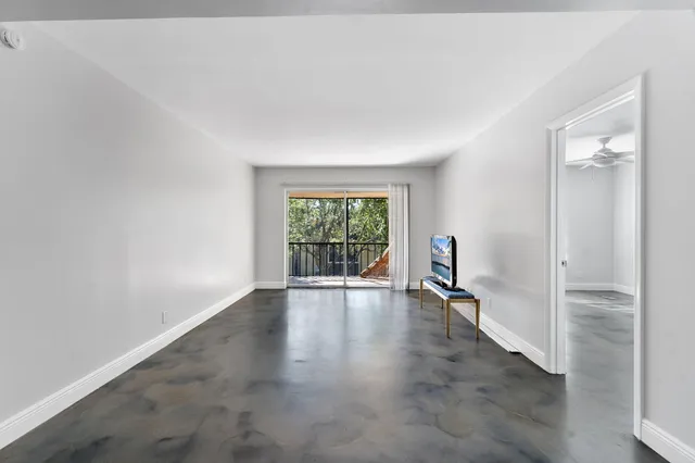 an empty room with wooden floor and a window