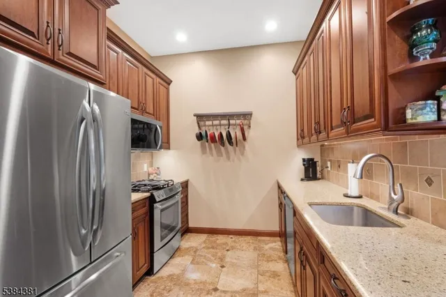 a kitchen with a stove a microwave and refrigerator