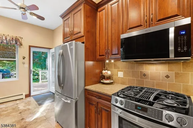 a kitchen with stainless steel appliances granite countertop a refrigerator and a sink