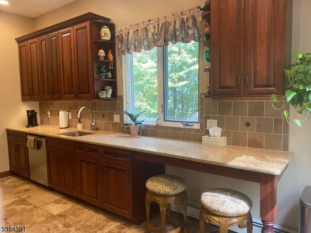 a kitchen with stainless steel appliances granite countertop a refrigerator and a stove
