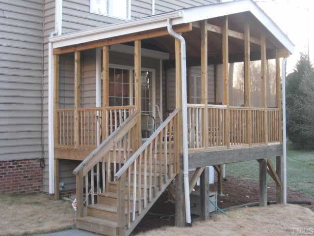 2912 New Hall Court Raleigh, NC 27615 - Photo 3 of 12 a view of wooden house with large windows and stairs
