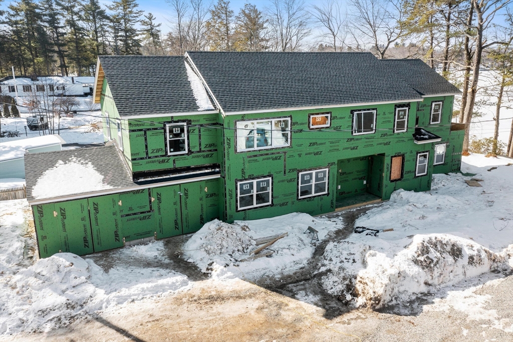 72 Laurel Lane, Unit 2 Lunenburg, MA 01462 - Photo 8 of 18 a view of a brick house with a yard plants and large tree