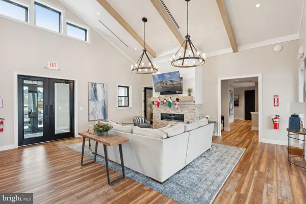 a kitchen with stainless steel appliances a dining table chairs and wooden floor