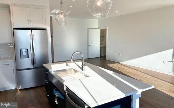 a kitchen with stainless steel appliances a refrigerator and a sink