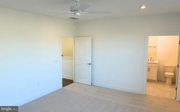 an empty room and a bathroom