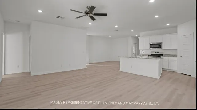 a view of kitchen with microwave and cabinets