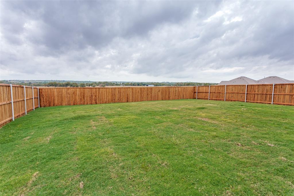 649 Fallbrook Drive Aledo, TX 76008 - Photo 21 of 30 a view of yard with swimming pool and wooden fence