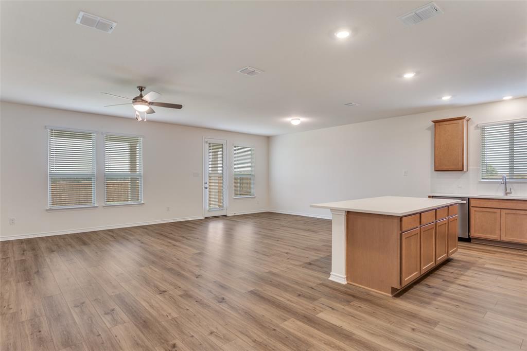 649 Fallbrook Drive Aledo, TX 76008 - Photo 4 of 30 a view of a kitchen with stainless steel appliances a white stove top oven and a wooden floors