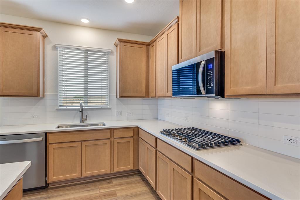 649 Fallbrook Drive Aledo, TX 76008 - Photo 7 of 30 a kitchen with sink cabinets and stove