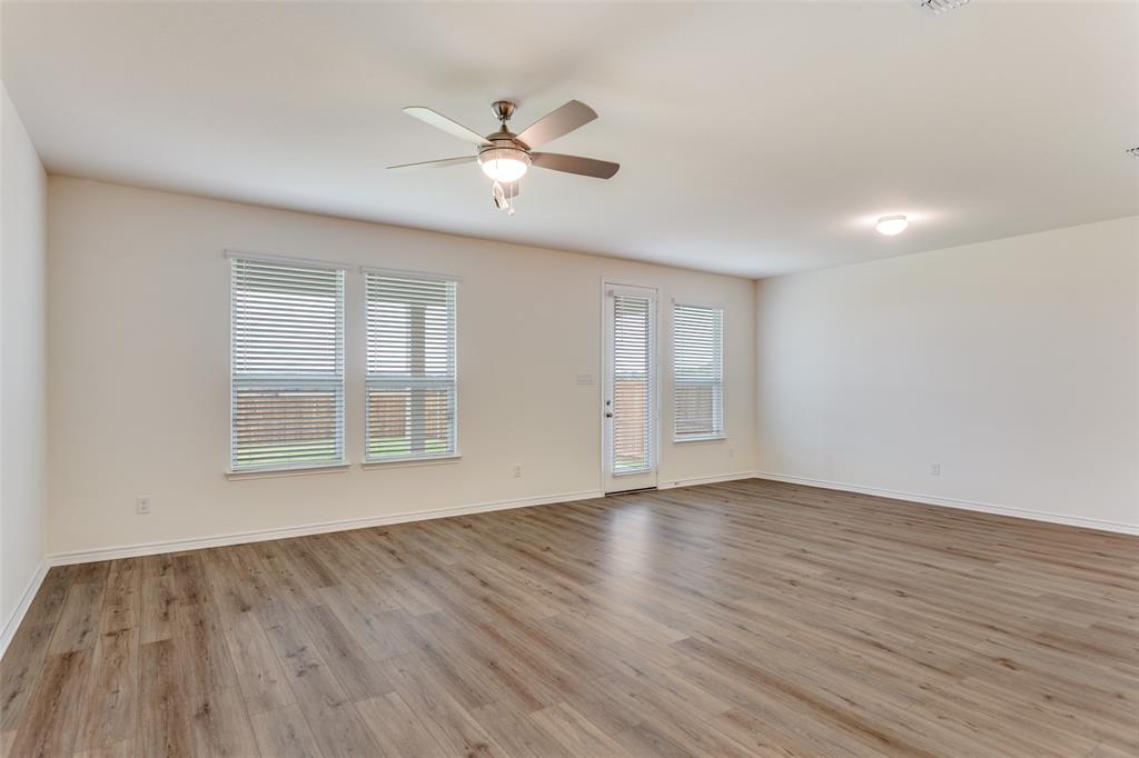 649 Fallbrook Drive Aledo, TX 76008 - Photo 9 of 30 a view of an empty room with wooden floor and a window