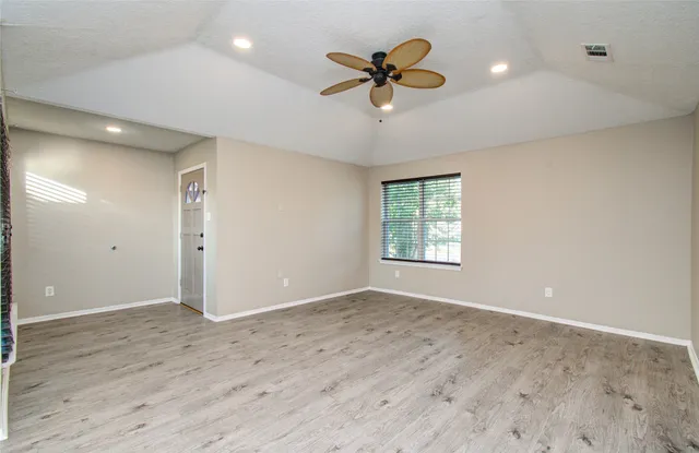 wooden floor in an empty room with a window