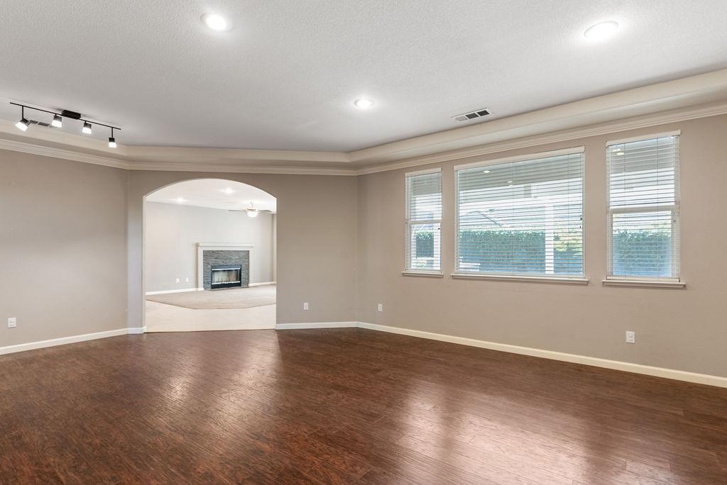 3604 Hillglen Avenue Modesto, CA 95355 - Photo 12 of 56 a view of an empty room with wooden floor and a window