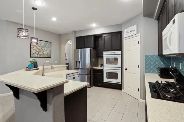 a kitchen with a sink and a wooden floors
