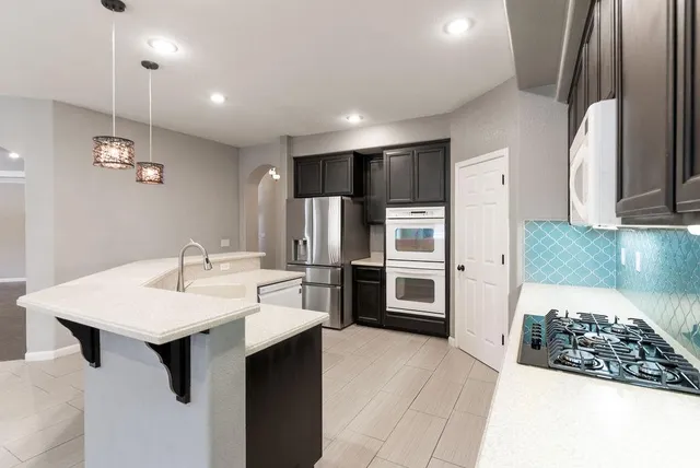 an empty room with windows and fireplace