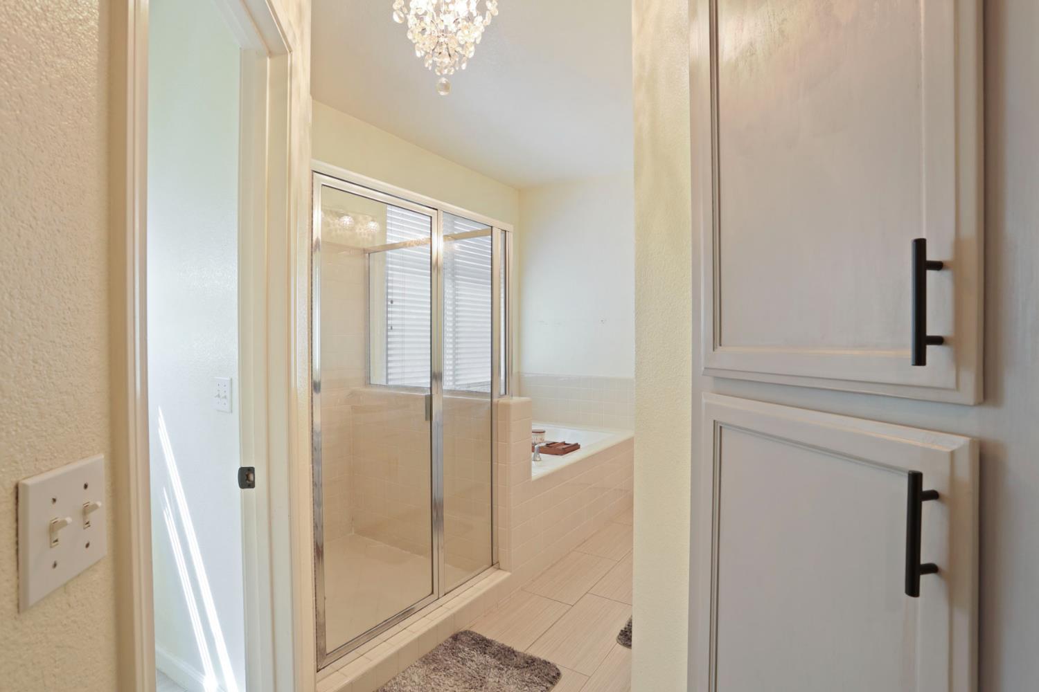 3604 Hillglen Avenue Modesto, CA 95355 - Photo 28 of 56 a bathroom with a glass shower door