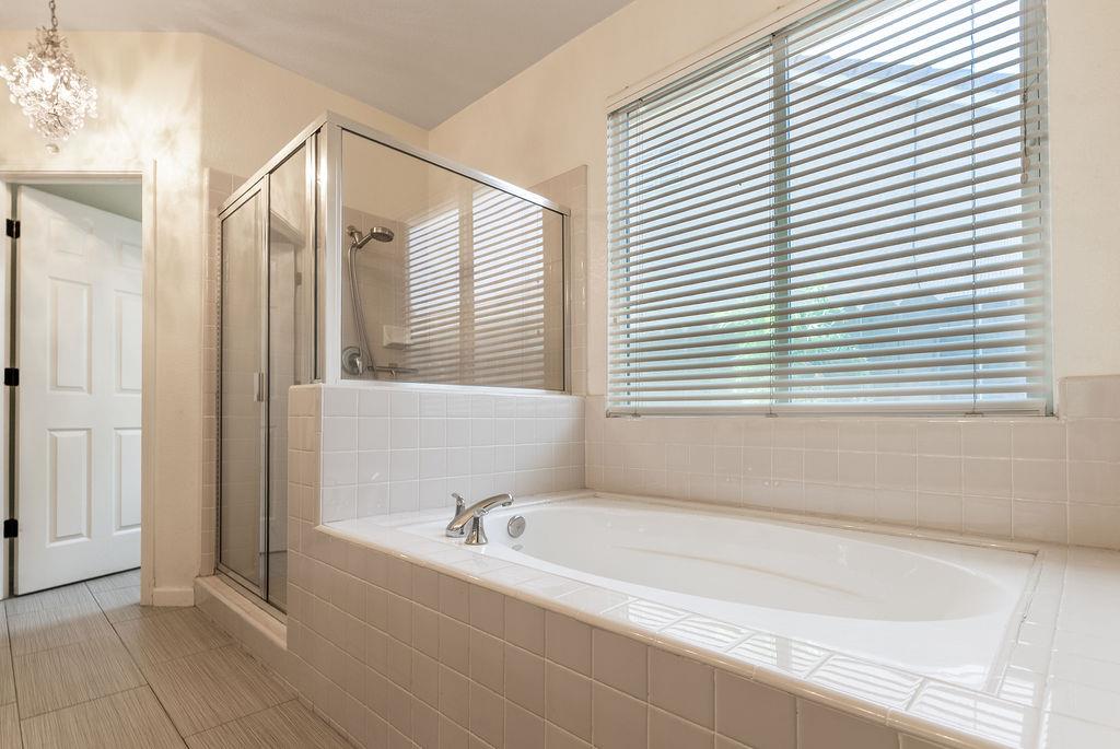 3604 Hillglen Avenue Modesto, CA 95355 - Photo 31 of 56 a bathroom with a bathtub and a shower