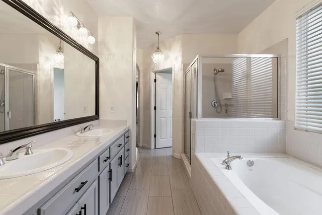 an empty room with a chandelier fan and closet area