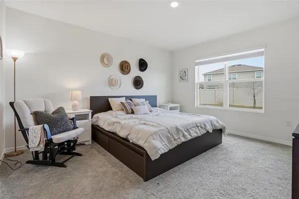 a bedroom with a bed and chair