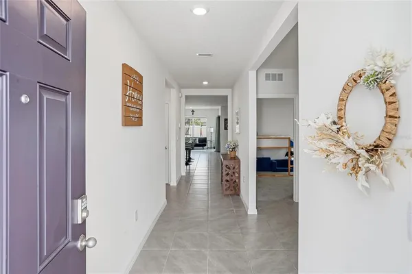 a view of a hallway with dining area and chandelier