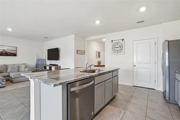 a kitchen with stainless steel appliances granite countertop a sink and a stove