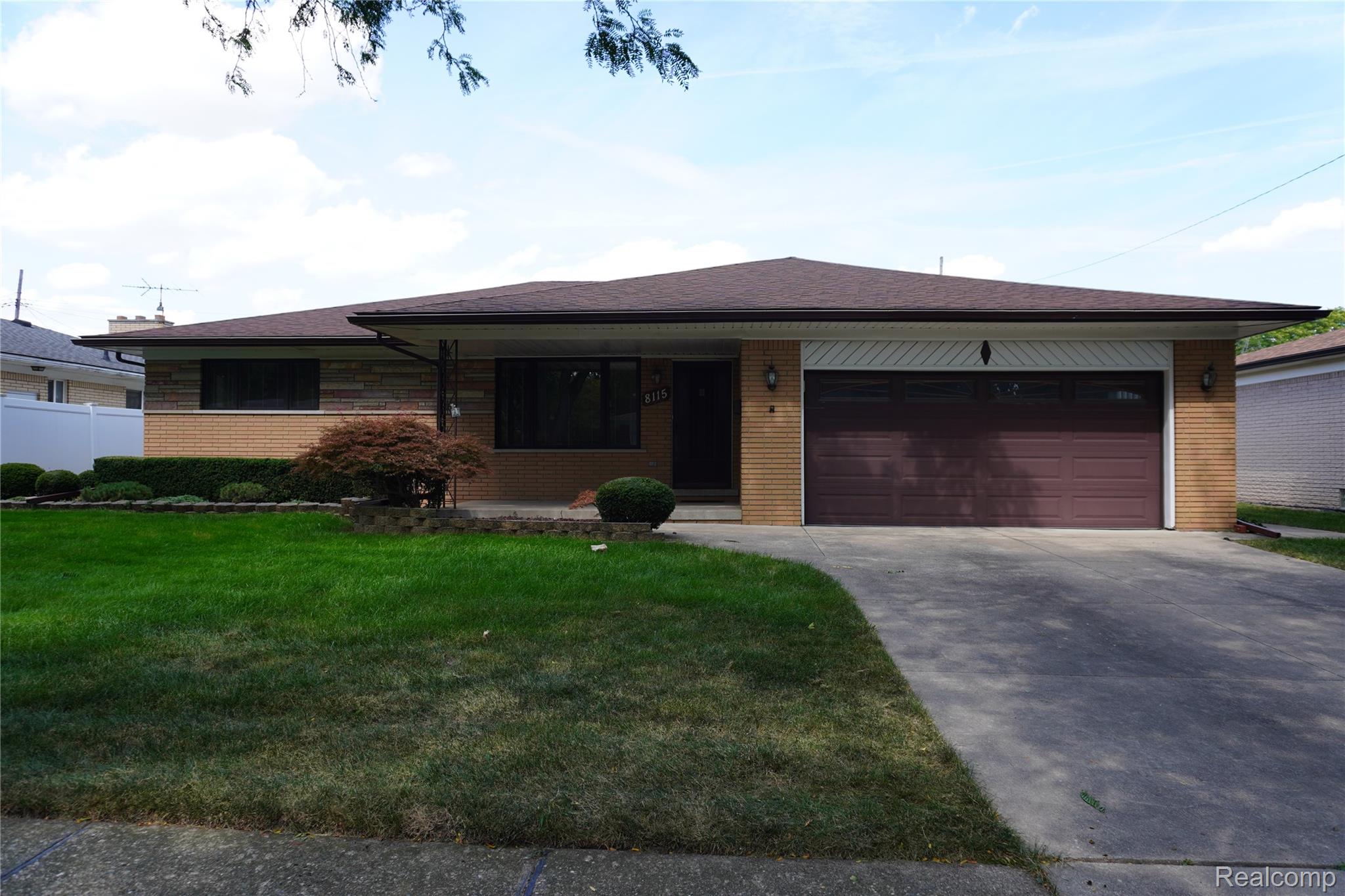 8115 Busch Street Center Line, MI 48015 - Photo 1 of 19 View of front of home with brick siding, driveway, a shingled roof, a garage, and a front yard