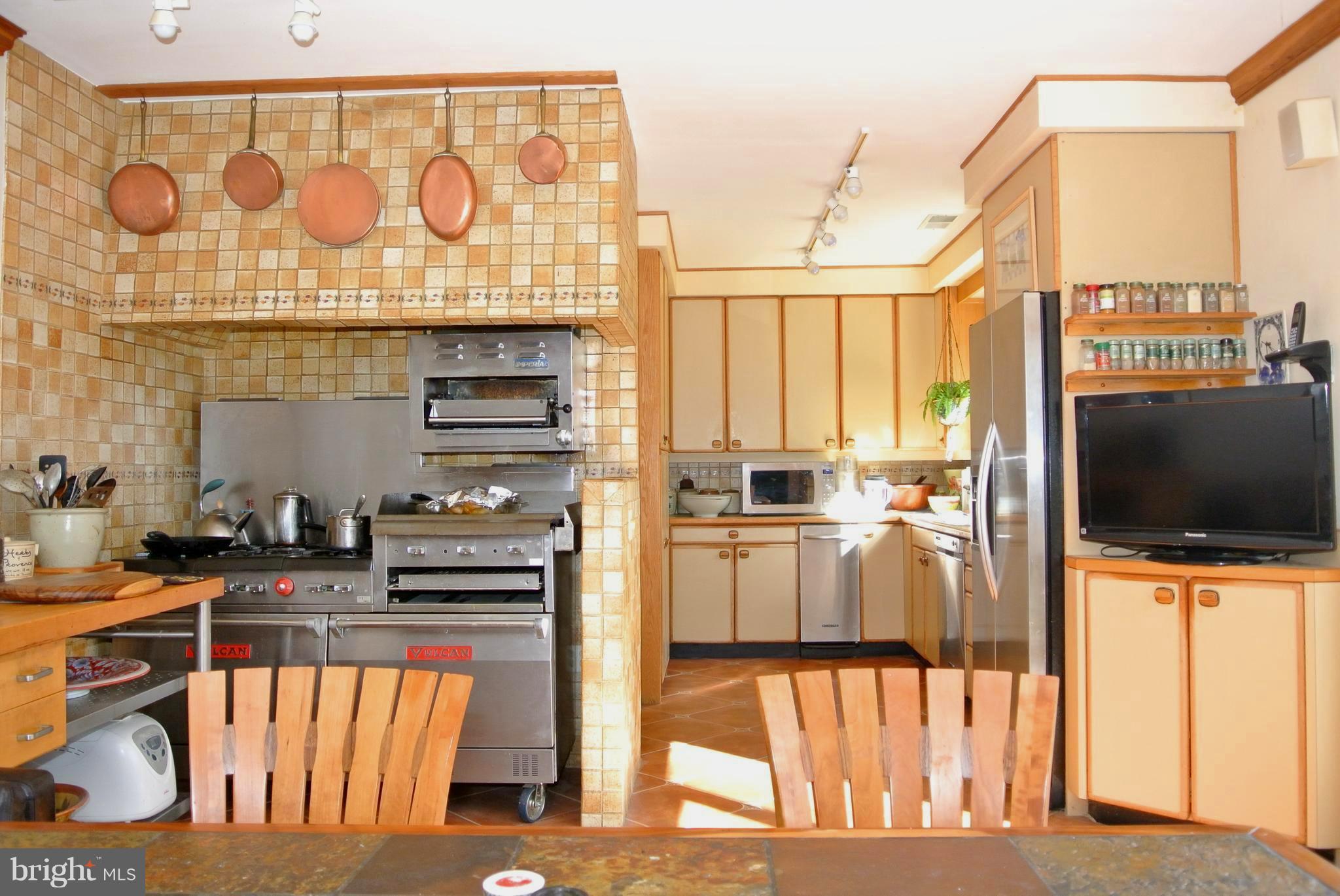 3864 Butler Road Reisterstown, MD 21136 - Photo 15 of 24 a kitchen with stainless steel appliances kitchen island granite countertop a stove and a sink