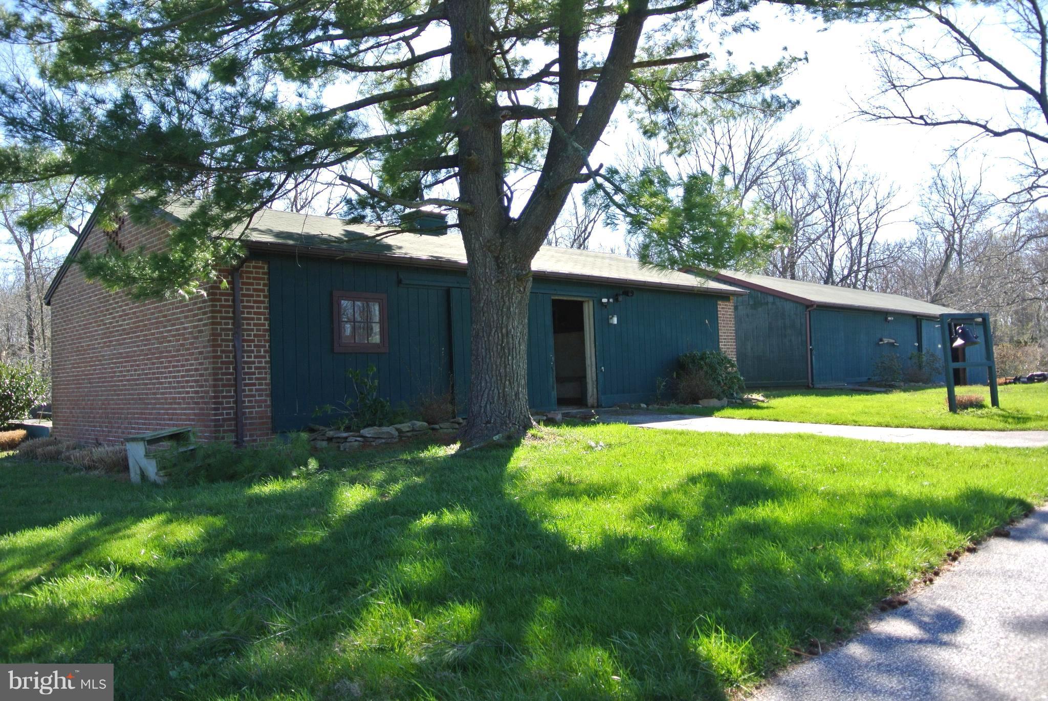 3864 Butler Road Reisterstown, MD 21136 - Photo 19 of 24 a front view of a house with a yard and garage