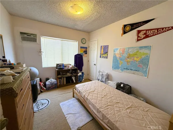 a kitchen with stainless steel appliances granite countertop a refrigerator a sink dishwasher a stove and white cabinets with wooden floor