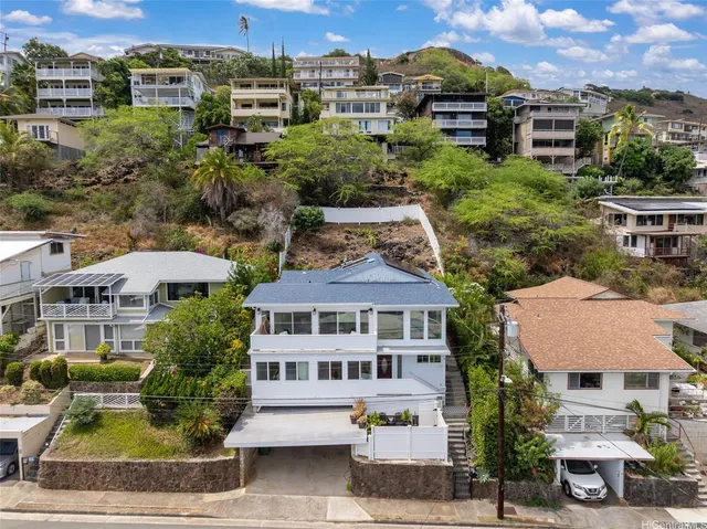 a front view of a residential houses with yard