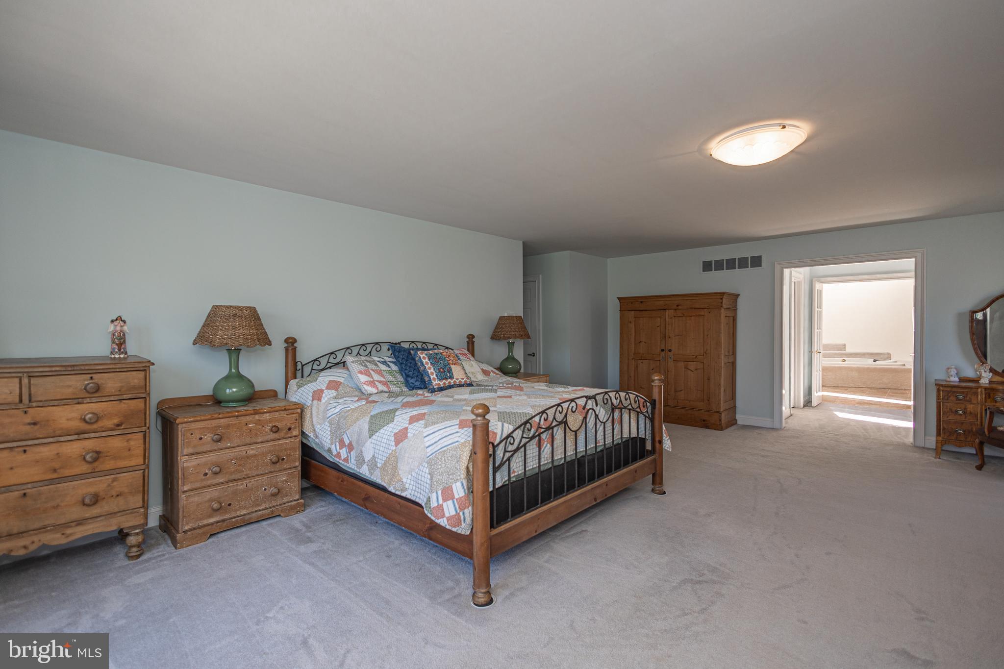 1045 Washington Crossing Road Newtown, PA 18940 - Photo 29 of 67 a bedroom with a bed and a lamp