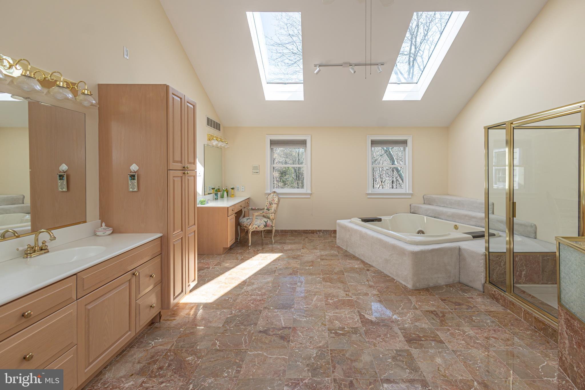 1045 Washington Crossing Road Newtown, PA 18940 - Photo 31 of 67 a spacious bathroom with a tub sink and mirror