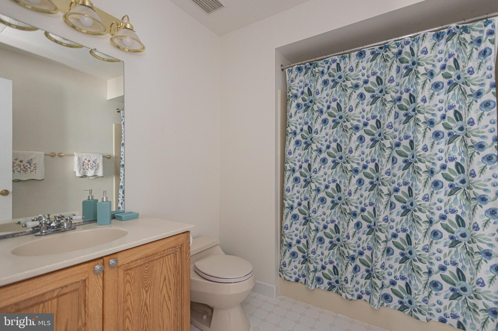 1045 Washington Crossing Road Newtown, PA 18940 - Photo 33 of 67 a bathroom with a granite countertop toilet a sink and a mirror
