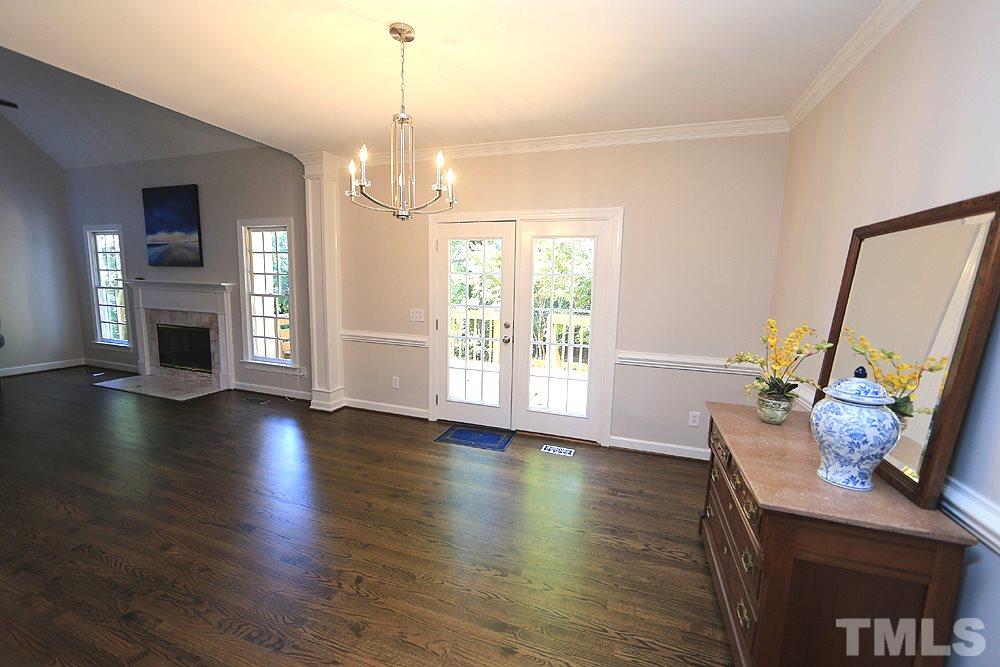 1901 Russell Drive Raleigh, NC 27612 - Photo 5 of 18 Dining Room open to Family Room with chair rail, french doors to deck and refinished hardwood floors.