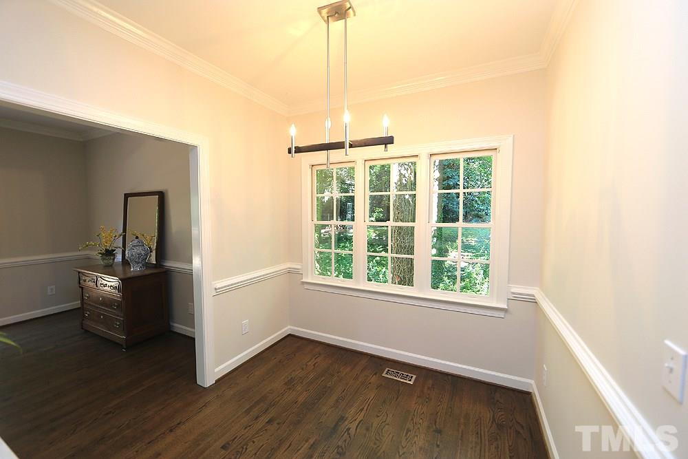 1901 Russell Drive Raleigh, NC 27612 - Photo 8 of 18 Breakfast Area off kitchen with triple windows, chair rail and peaceful wooded area view.