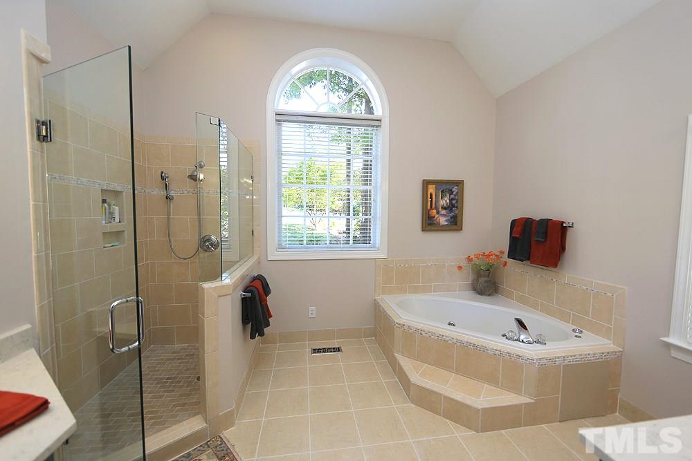 1901 Russell Drive Raleigh, NC 27612 - Photo 10 of 18 Awesome Master Bath with volume ceilings, special shape window, separate vanities, whirlpool tub, shower and tile floors.