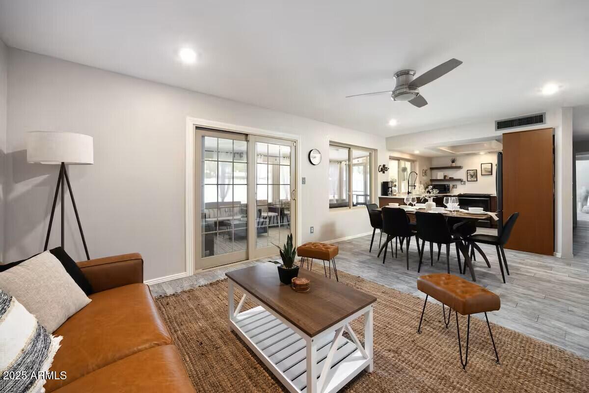 922 West Monte Avenue Mesa, AZ 85210 - Photo 12 of 41 a living room with furniture a wooden floor and a window