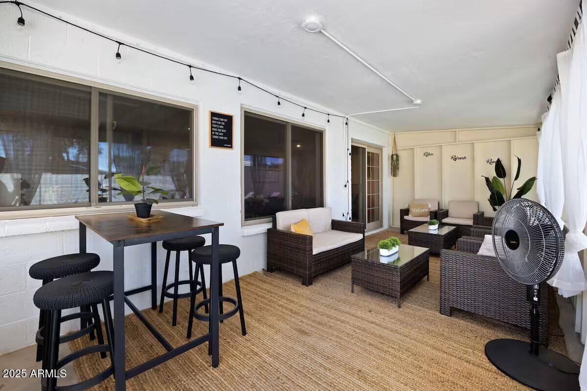 922 West Monte Avenue Mesa, AZ 85210 - Photo 20 of 41 a living room with furniture a chandelier and a wooden floor