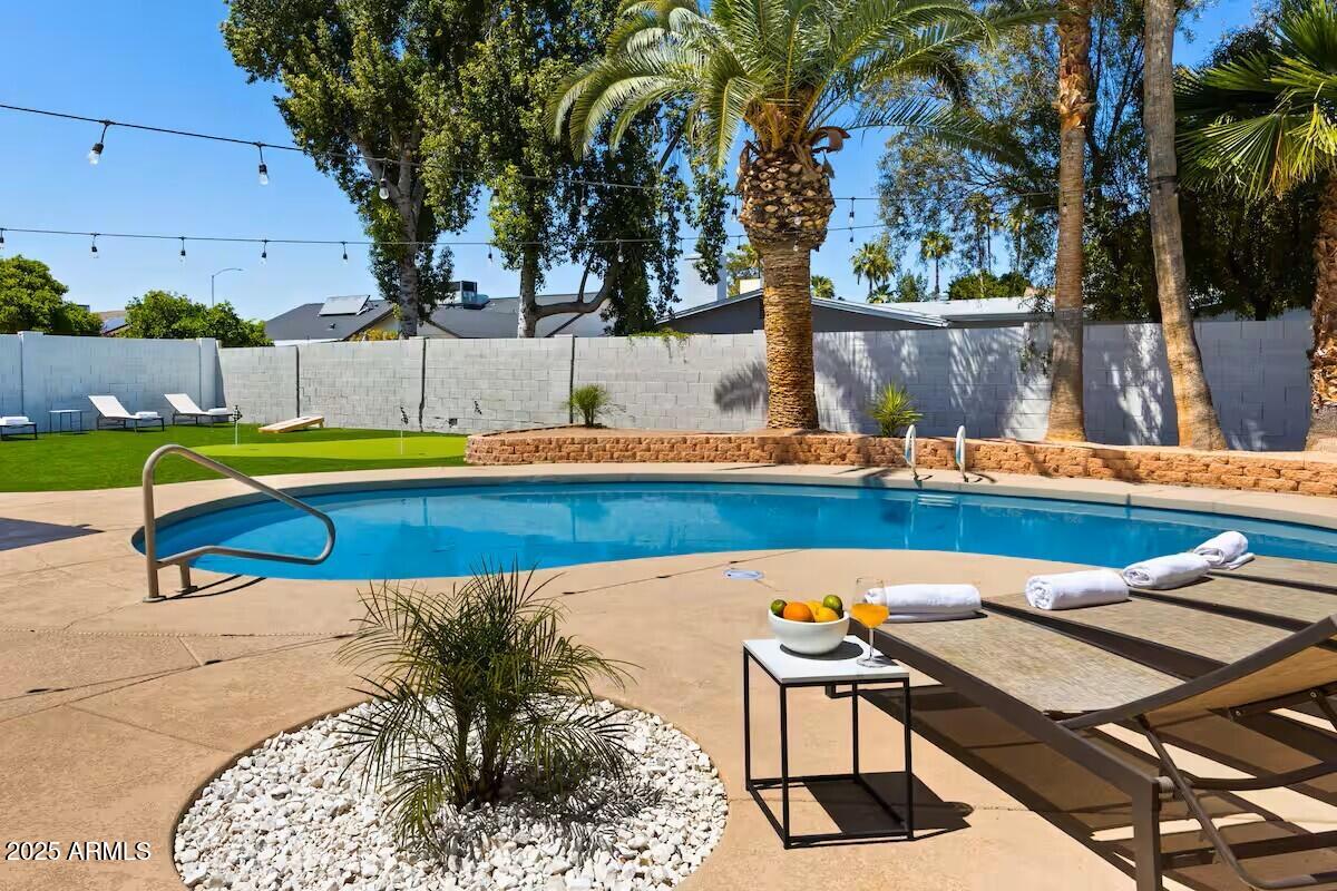 922 West Monte Avenue Mesa, AZ 85210 - Photo 2 of 41 a swimming pool with outdoor seating and yard