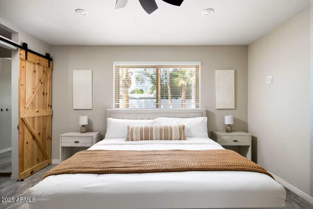 922 West Monte Avenue Mesa, AZ 85210 - Photo 22 of 41 a bedroom with a large bed and a window