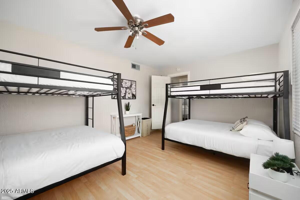 922 West Monte Avenue Mesa, AZ 85210 - Photo 24 of 41 a bedroom with a bed and a chandelier