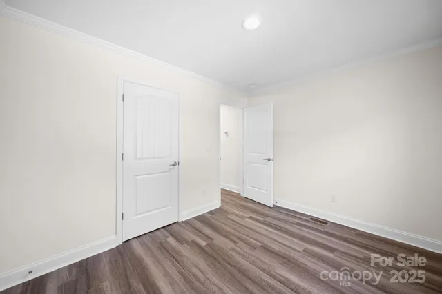 a view of an empty room and wooden floor