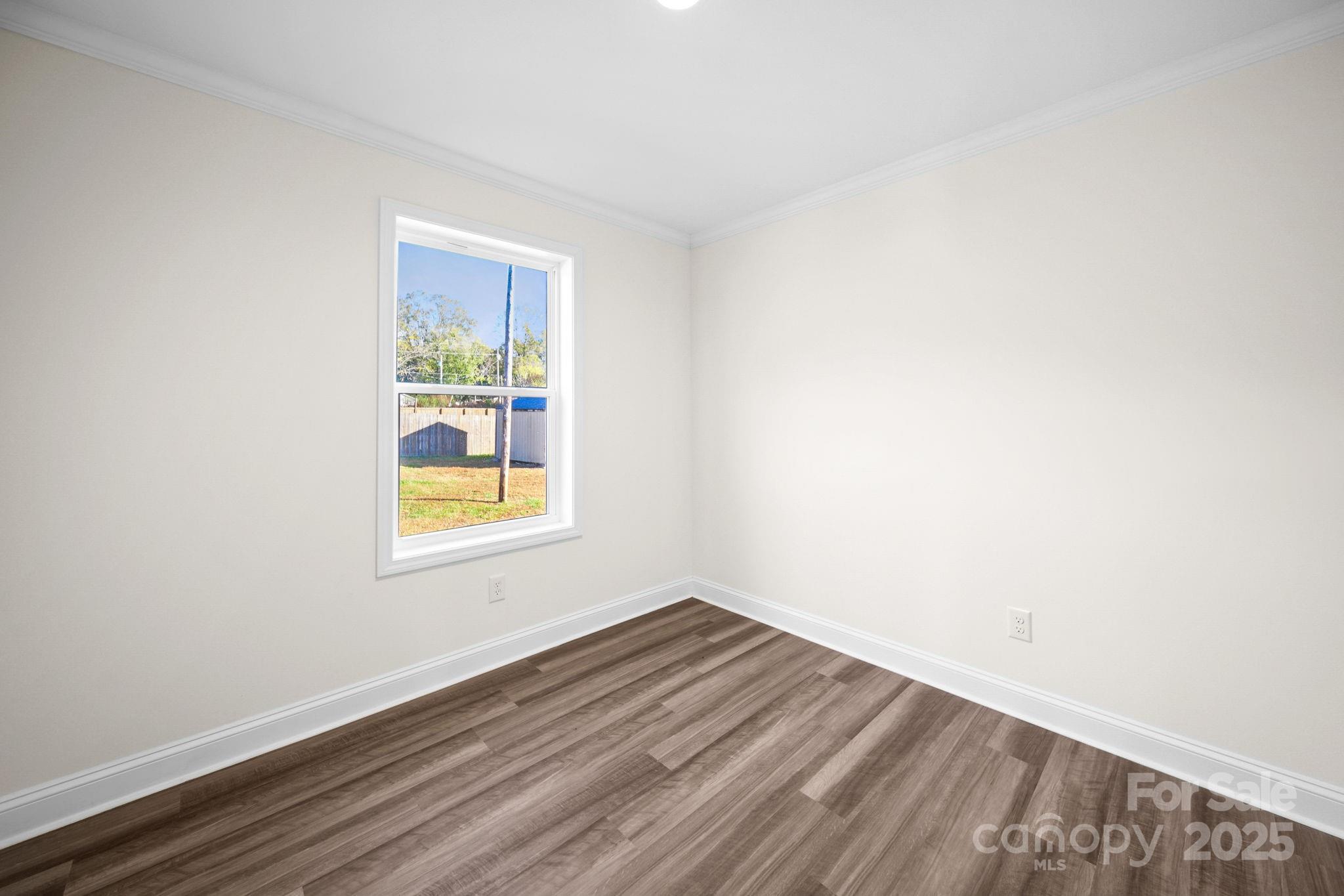 159 Hallman Street Cherryville, NC 28021 - Photo 19 of 22 a view of an empty room with wooden floor and a window