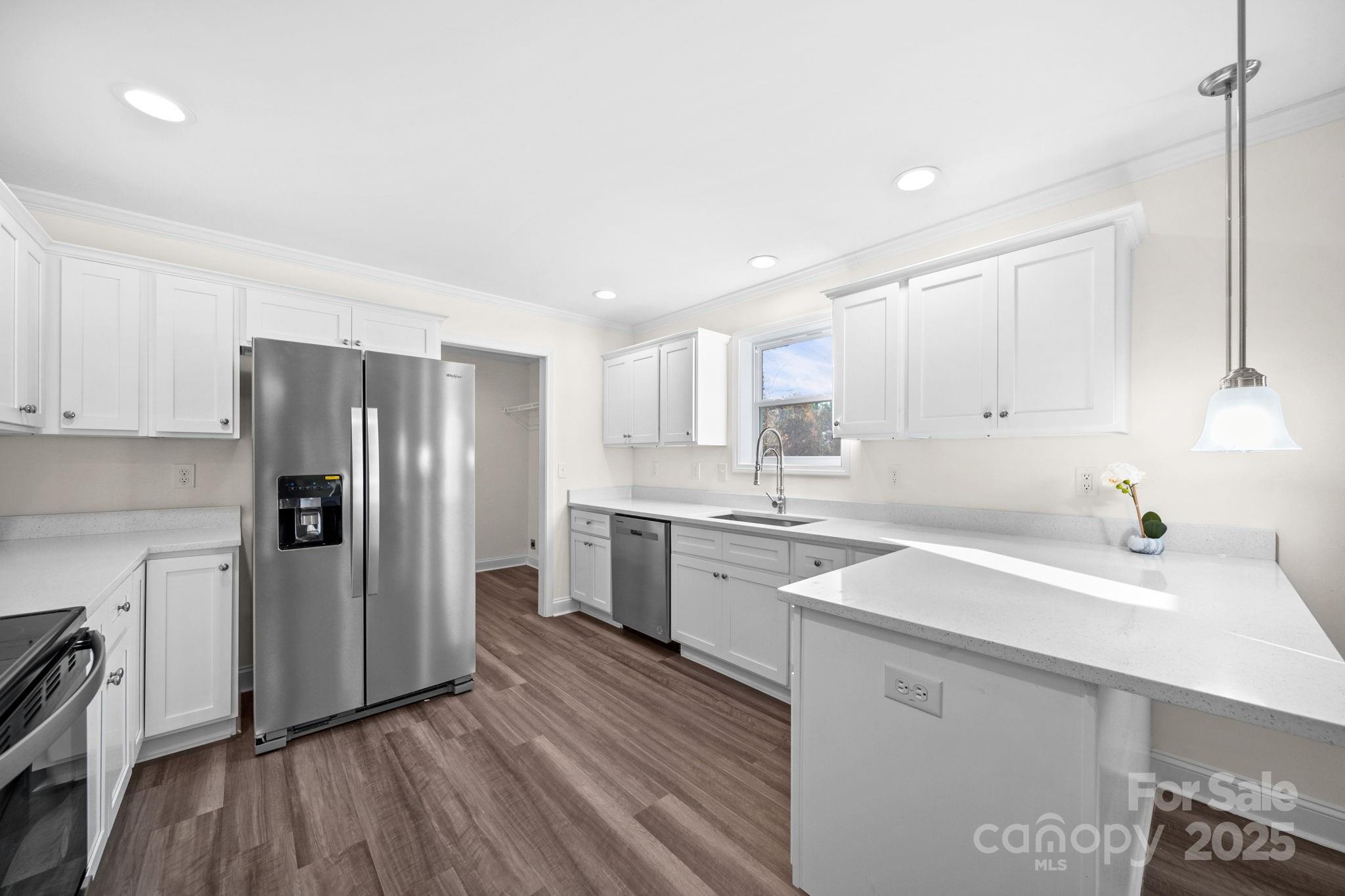 159 Hallman Street Cherryville, NC 28021 - Photo 6 of 22 a kitchen with a sink wooden floor and stainless steel appliances