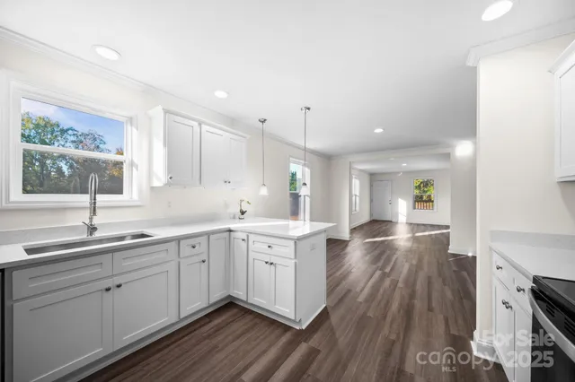 a kitchen with a sink stove and cabinets
