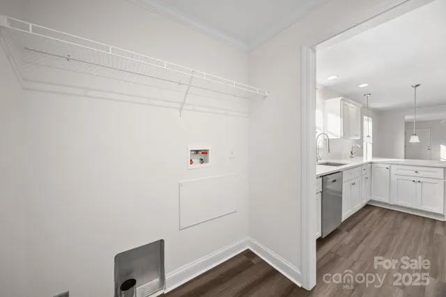a kitchen with cabinets and wooden floor