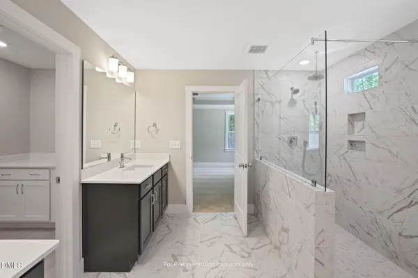 a bathroom with a double vanity sink mirror and shower