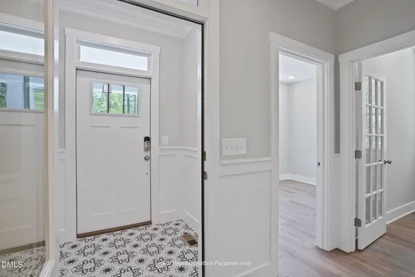 a view of a hallway with wooden floor